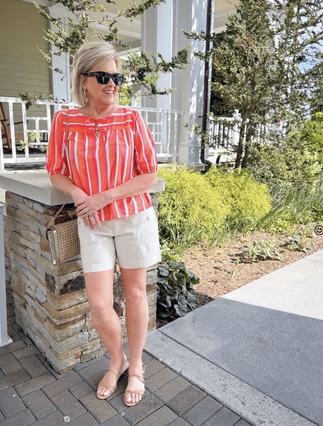 Watercolor striped tie-front top with linen utility shorts, styled with cork sandals and a rattan clutch